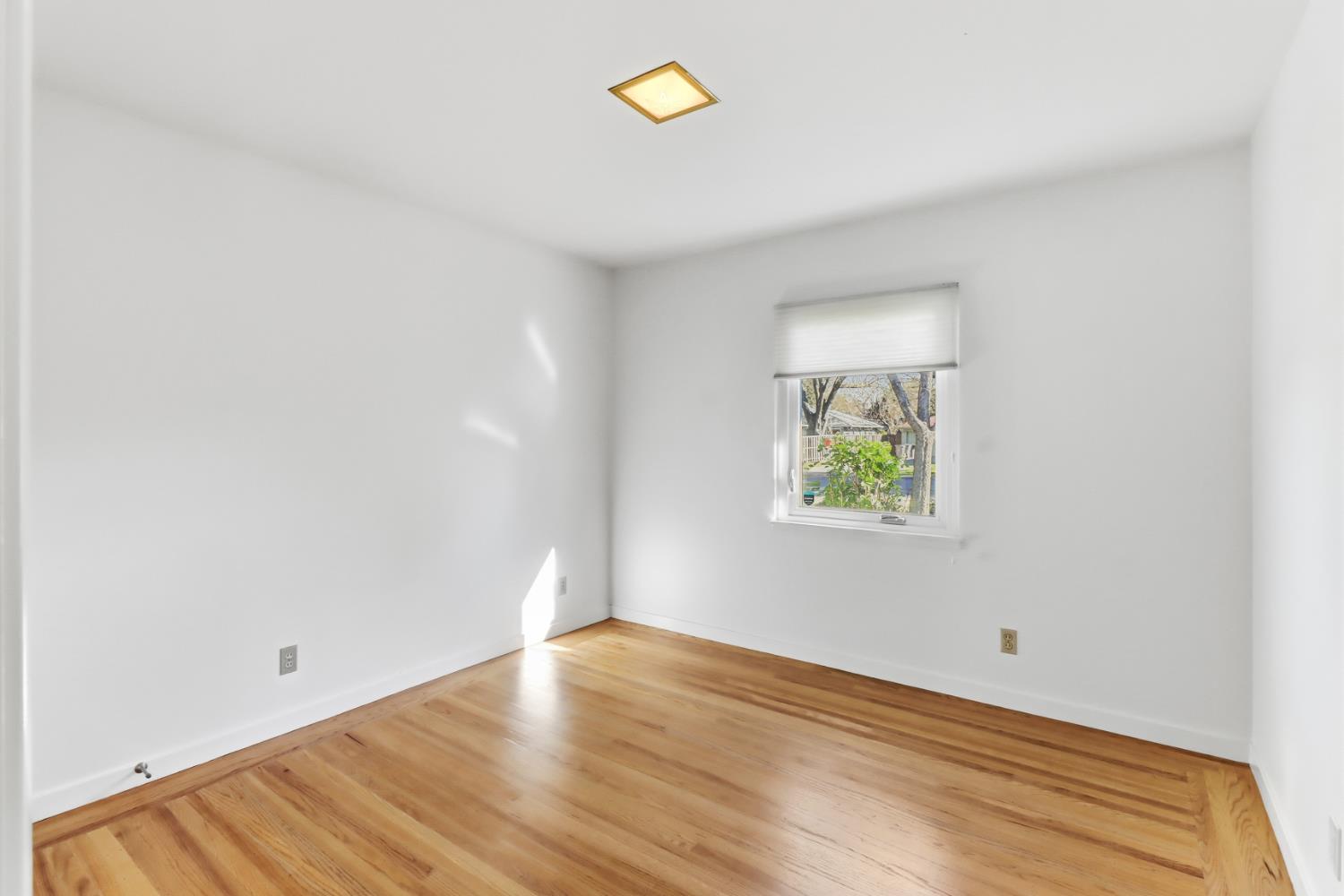 709 A Street Davis, CA 95616 - Photo 39 of 74 a view of room with window and wooden floor