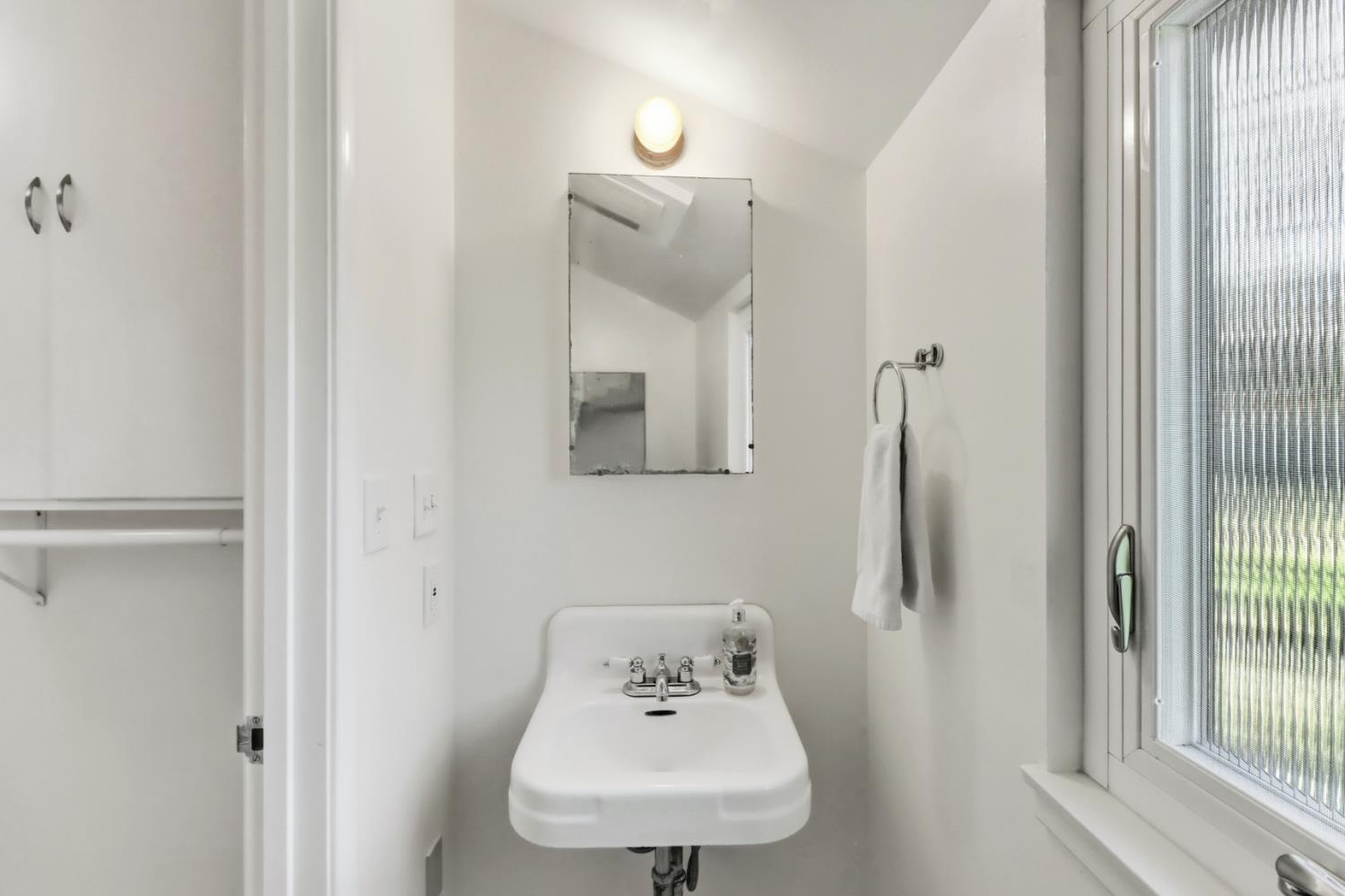 709 A Street Davis, CA 95616 - Photo 43 of 74 a bathroom with a sink mirror and window