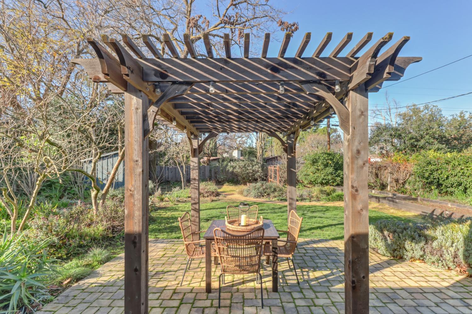 709 A Street Davis, CA 95616 - Photo 45 of 74 a patio with water view fountain with plants and large trees
