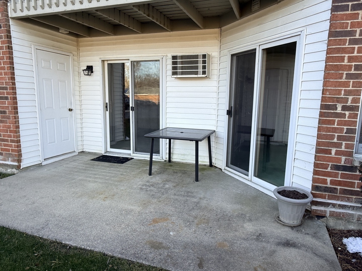 1345 Cunat Court, Unit 1B Lake In The Hills, IL 60156 - Photo 14 of 16 a view of a house with a patio and a window
