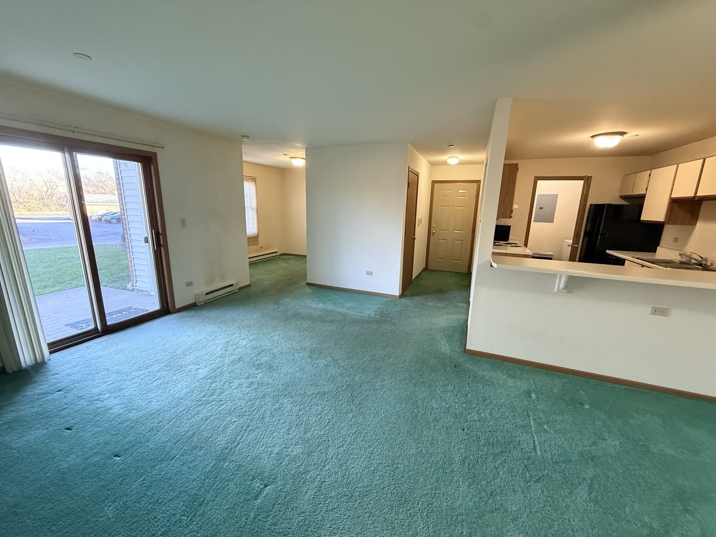 1345 Cunat Court, Unit 1B Lake In The Hills, IL 60156 - Photo 2 of 16 a view of a kitchen with refrigerator and window