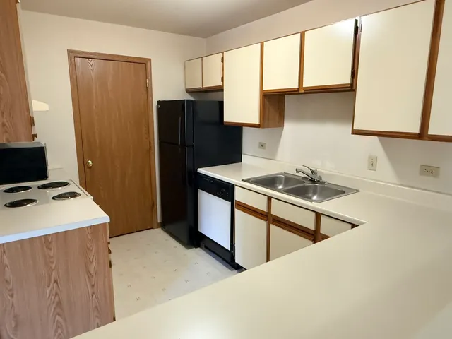 a kitchen with a stove a refrigerator and a sink
