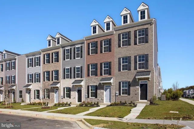 a front view of a residential apartment building with a yard