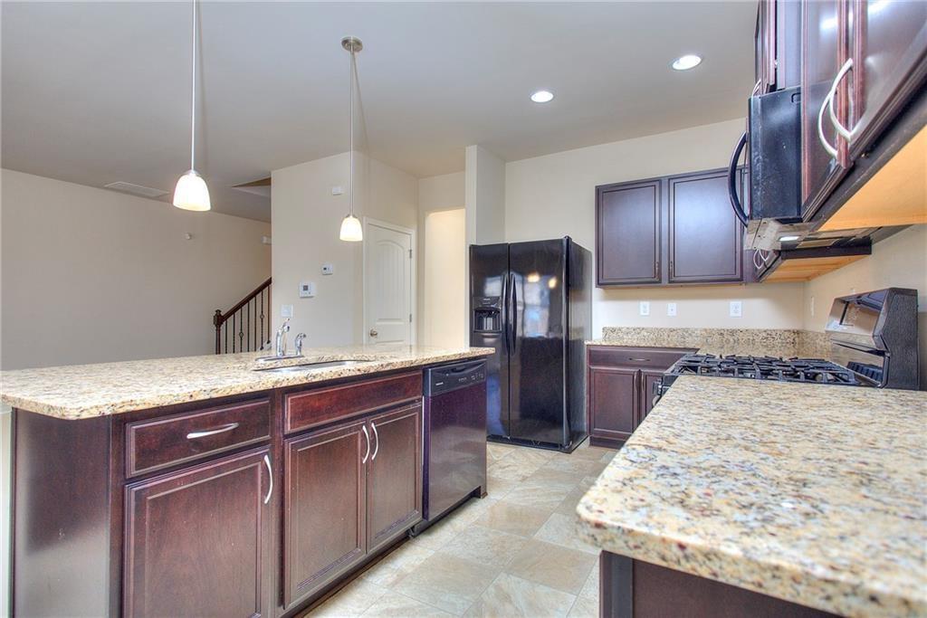 565 Dasheill Lane Atlanta, GA 30349 - Photo 4 of 11 a kitchen with a sink a counter top space appliances and cabinets