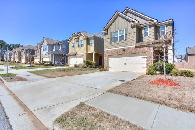 565 Dasheill Lane Atlanta, GA 30349 - Photo 10 of 11 a front view of a house with a yard and garage