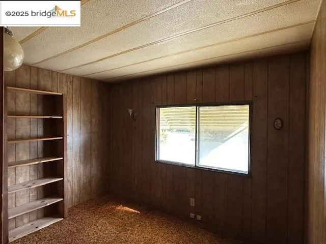 a view of an empty room and a window