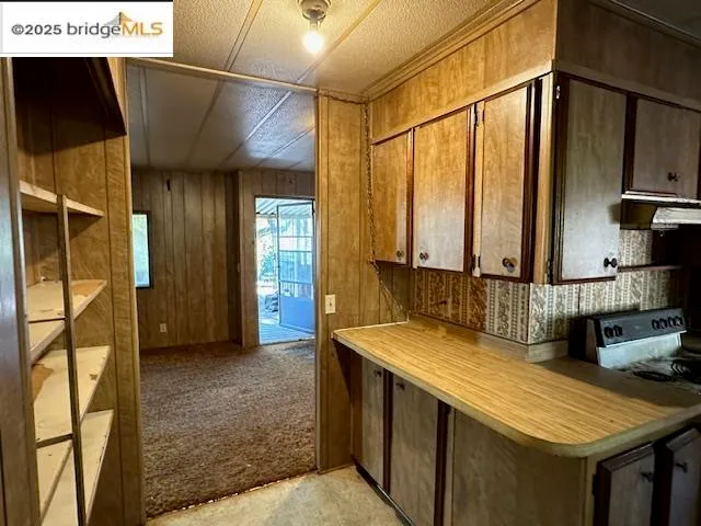 a kitchen with stainless steel appliances granite countertop a sink and cabinets