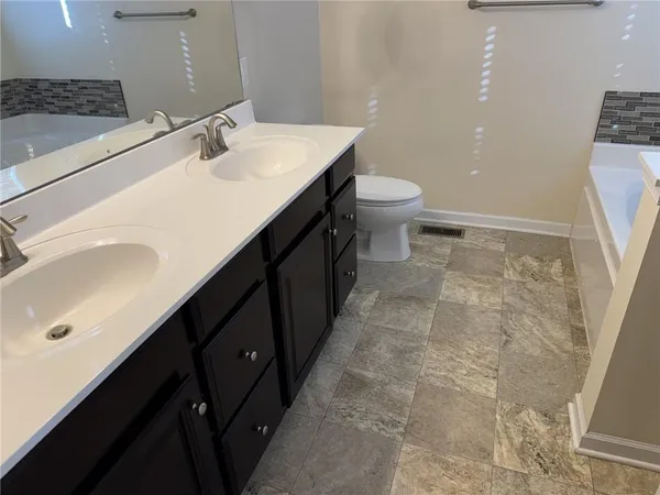 a bathroom with a sink a toilet and a mirror