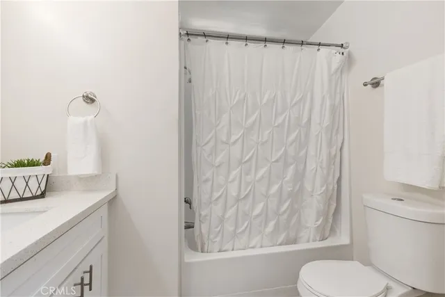 a white toilet sitting next to a bathroom sink