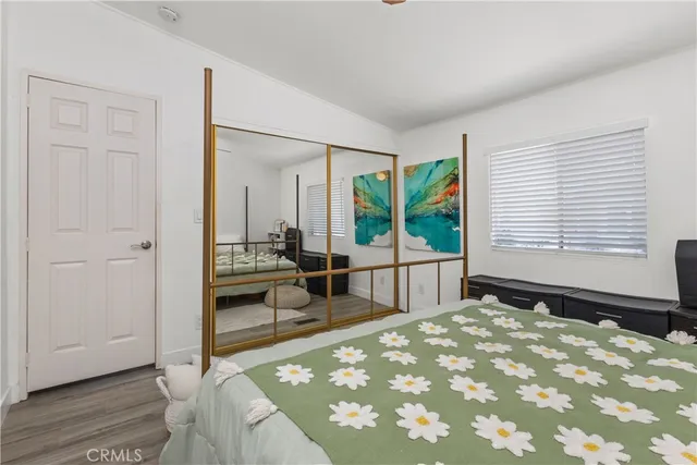 a bedroom with a bed and a large window