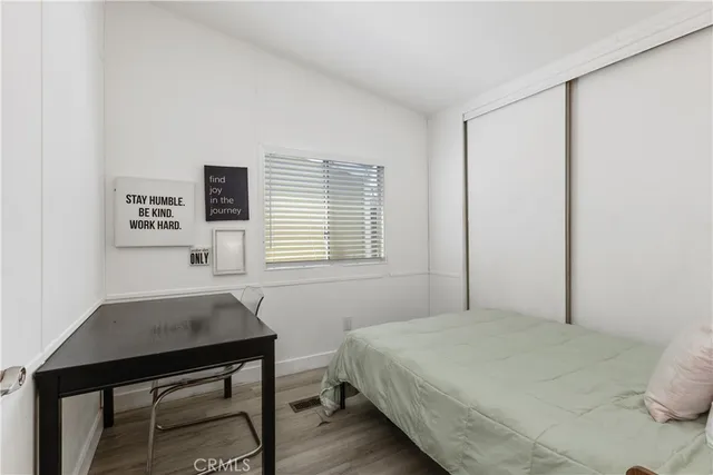 a bedroom with a bed and a desk