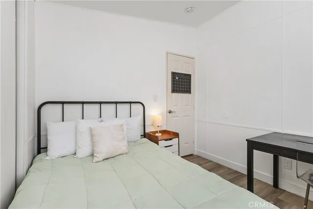 a bed room with a bed and a lamp