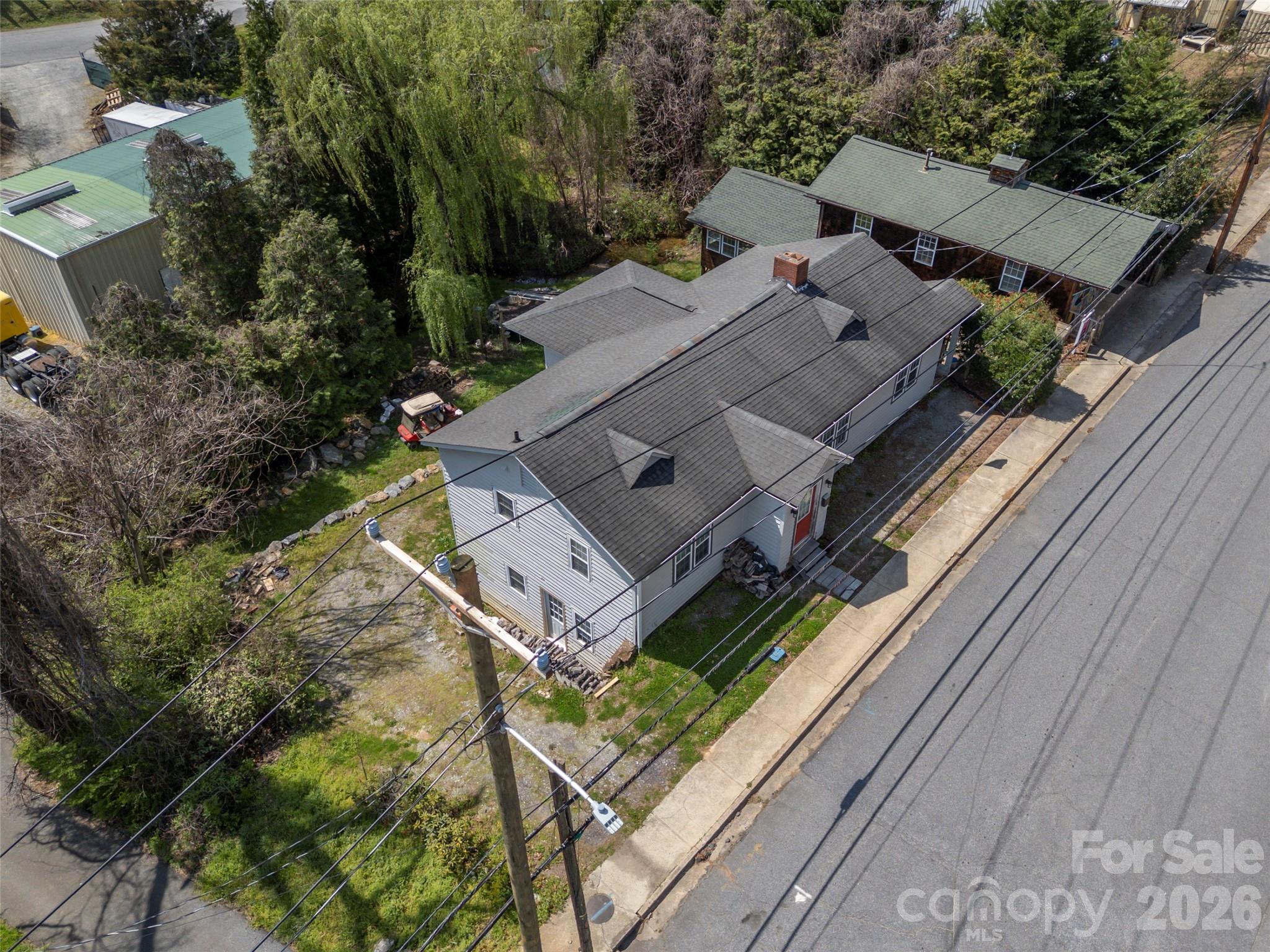 120 East Howard Street Tryon, NC 28782 - Photo 2 of 31 an aerial view of a house with a garden