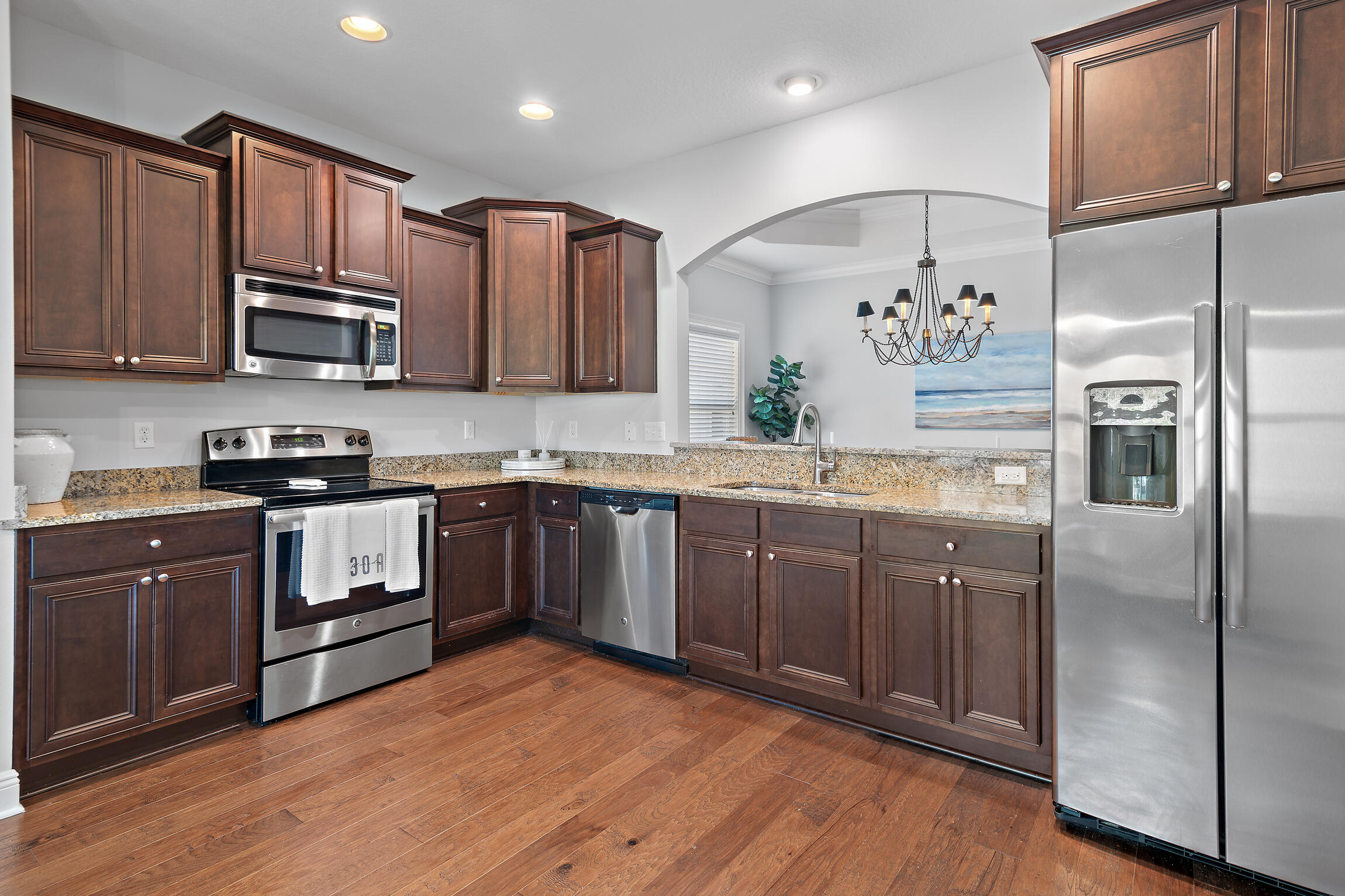 90 Ocean Spray Circle Santa Rosa Beach, FL 32459 - Photo 11 of 57 a kitchen with granite countertop stainless steel appliances and wooden cabinets