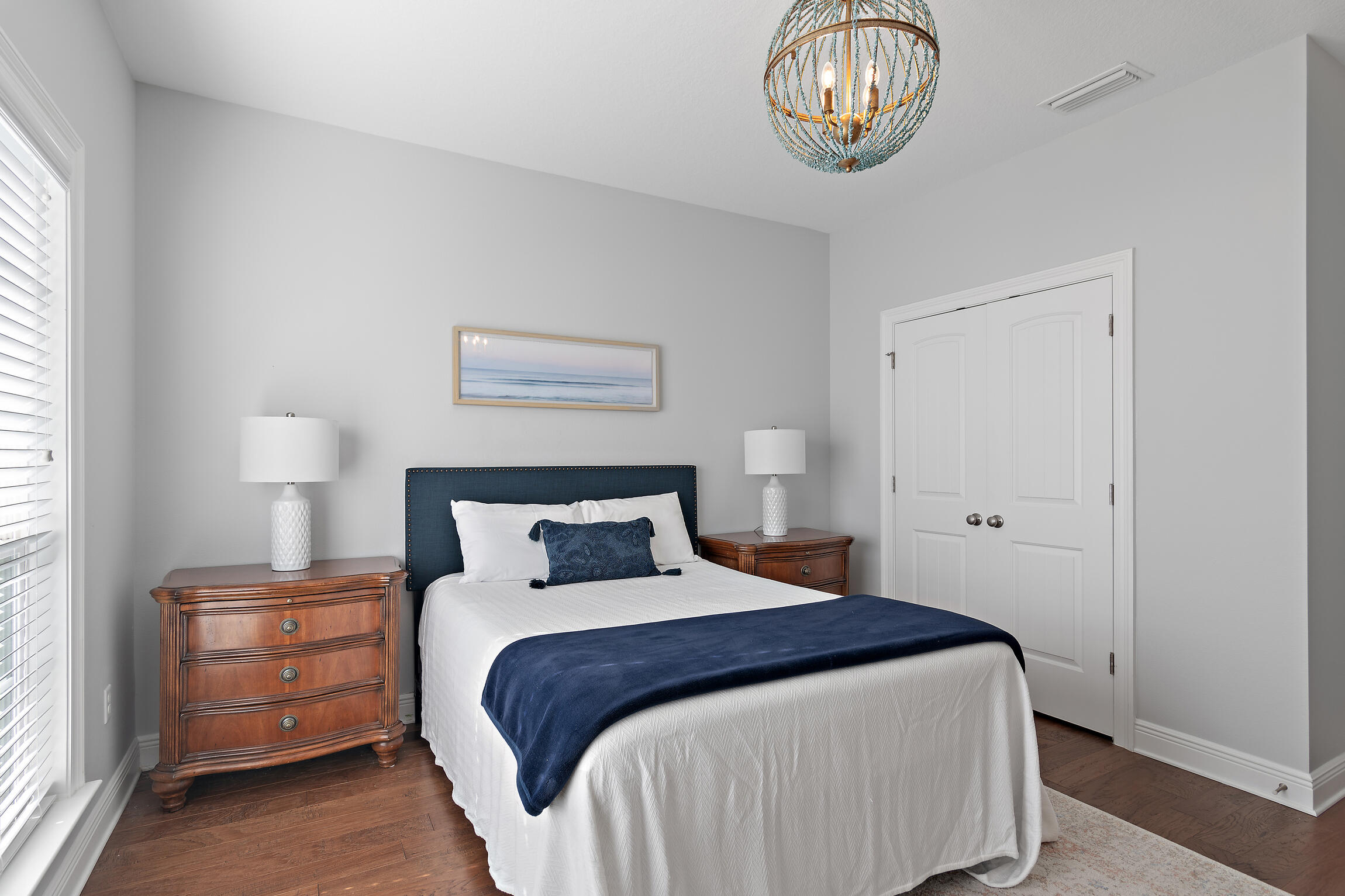 90 Ocean Spray Circle Santa Rosa Beach, FL 32459 - Photo 23 of 57 a bedroom with a bed and a chandelier