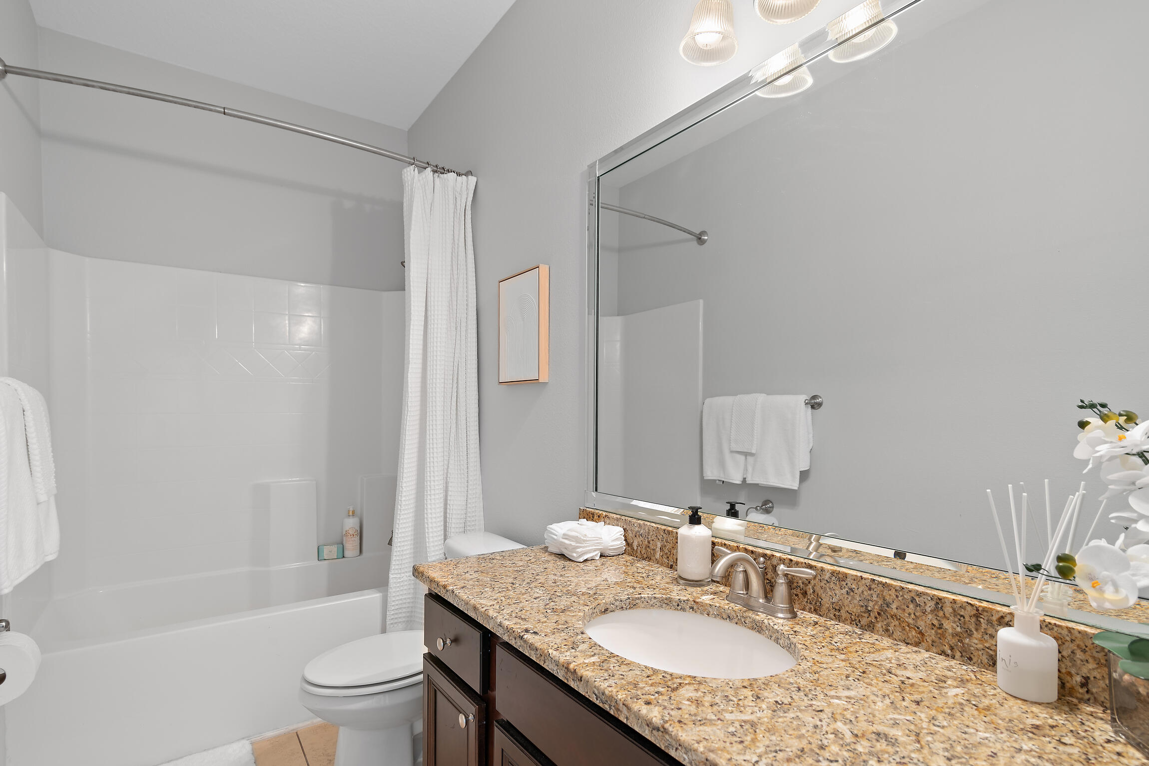 90 Ocean Spray Circle Santa Rosa Beach, FL 32459 - Photo 25 of 57 a bathroom with a granite countertop sink a toilet a mirror a bathtub and shower