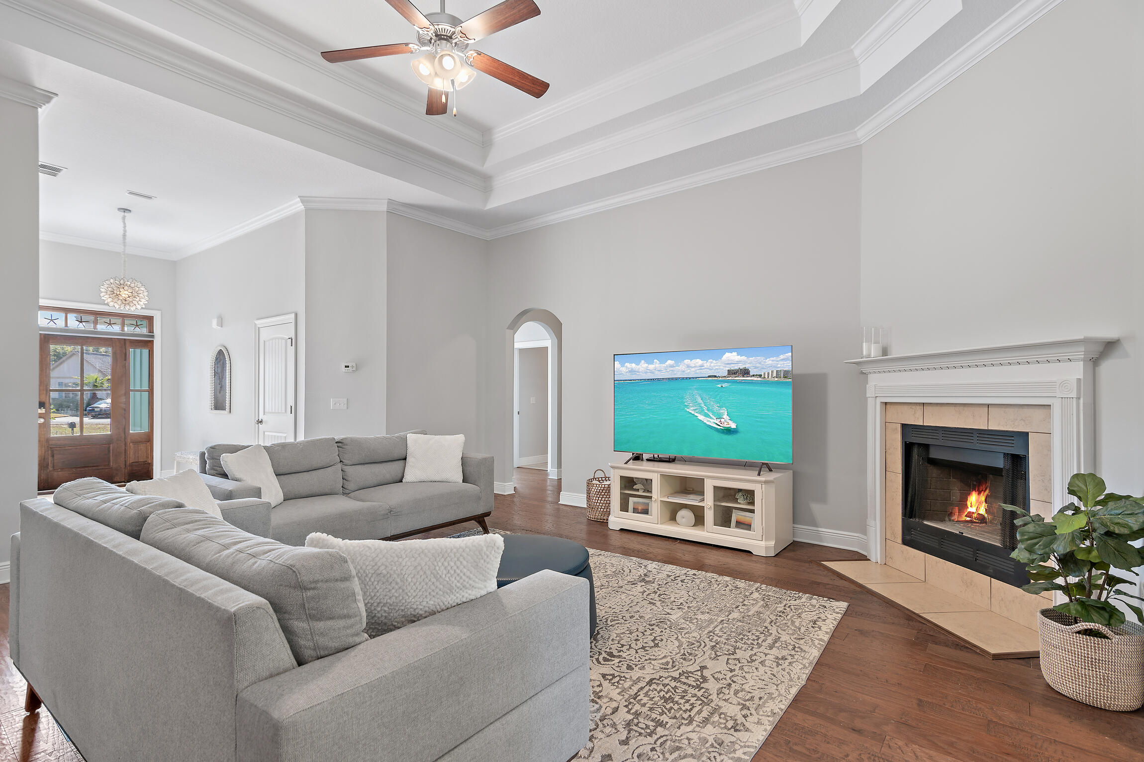 90 Ocean Spray Circle Santa Rosa Beach, FL 32459 - Photo 5 of 57 a living room with furniture a flat screen tv and a fireplace