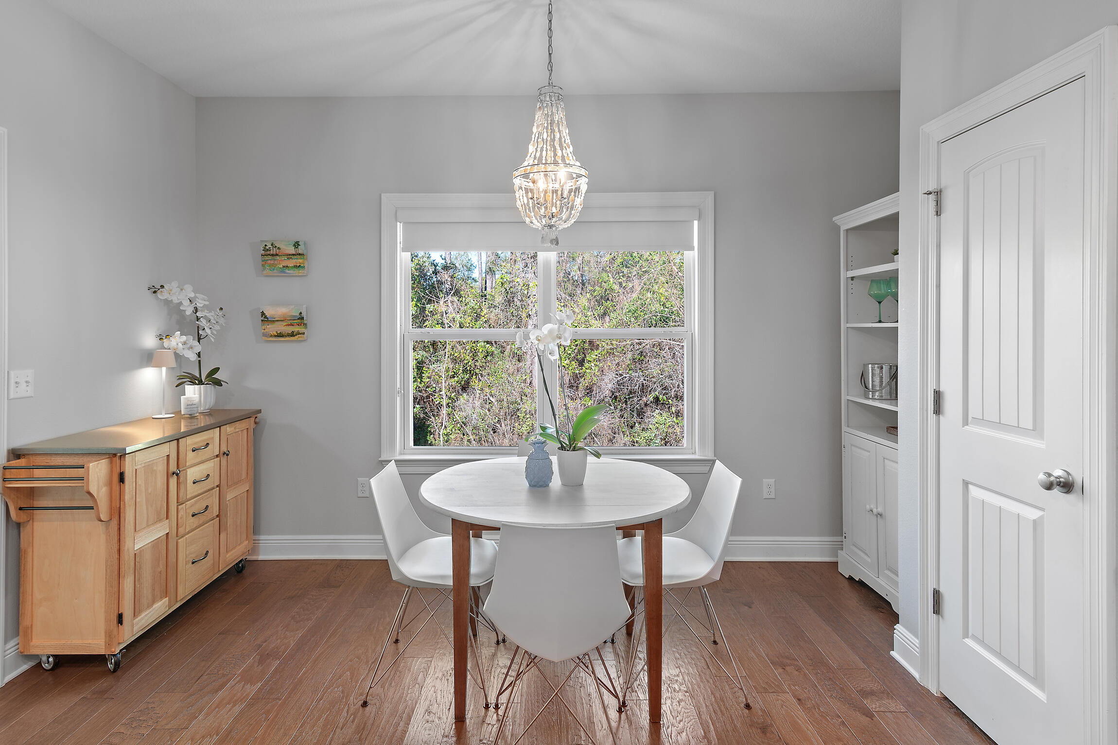 90 Ocean Spray Circle Santa Rosa Beach, FL 32459 - Photo 9 of 57 a dining room with furniture a chandelier and wooden floor