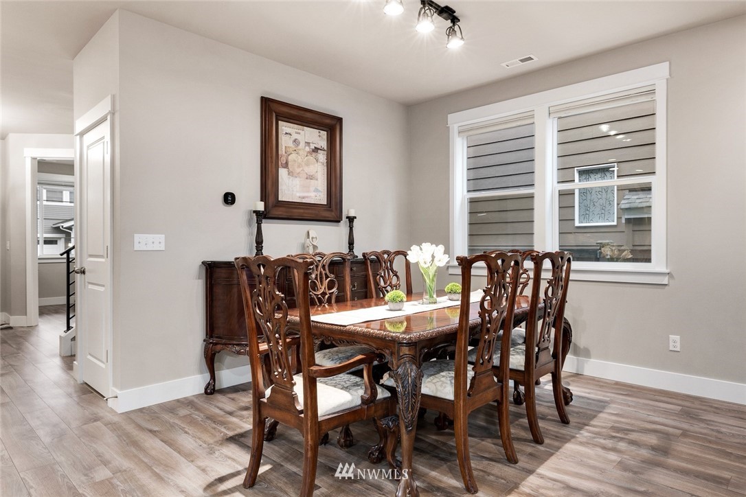 3615 177th Street Southeast Bothell, WA 98012 - Photo 8 of 32 a view of a dining room with furniture and wooden floor