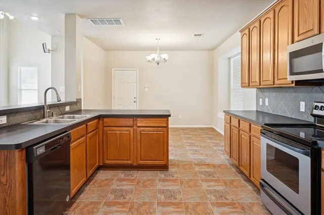 a kitchen with stainless steel appliances granite countertop a sink stove and cabinets