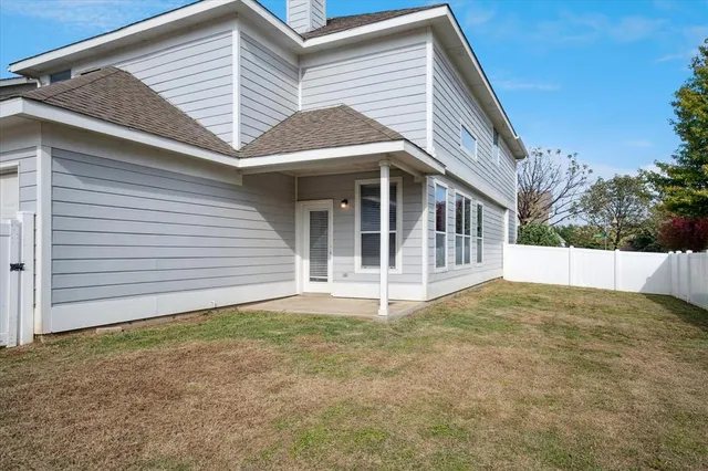 a view of house with backyard and deck