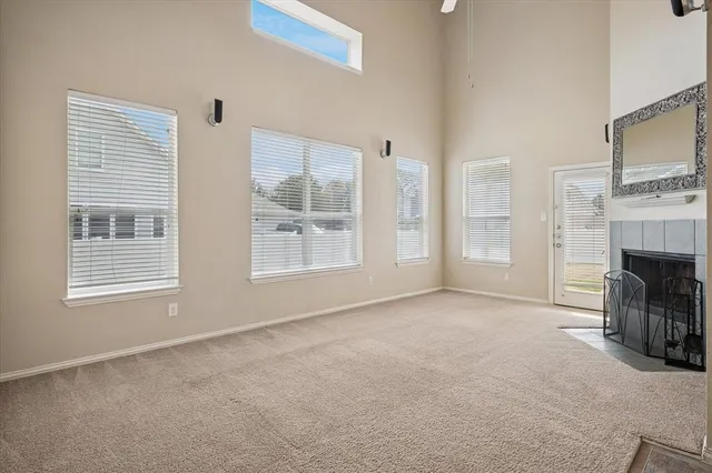 a view of livingroom with furniture fireplace and window