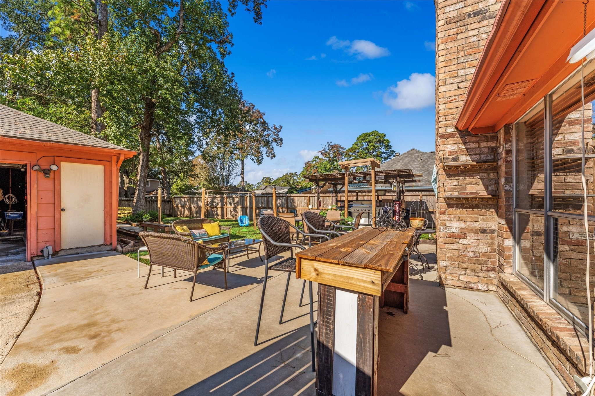 19527 Enchanted Spring Drive Spring, TX 77388 - Photo 24 of 33 a view of a patio with table and chairs with wooden floor and fence