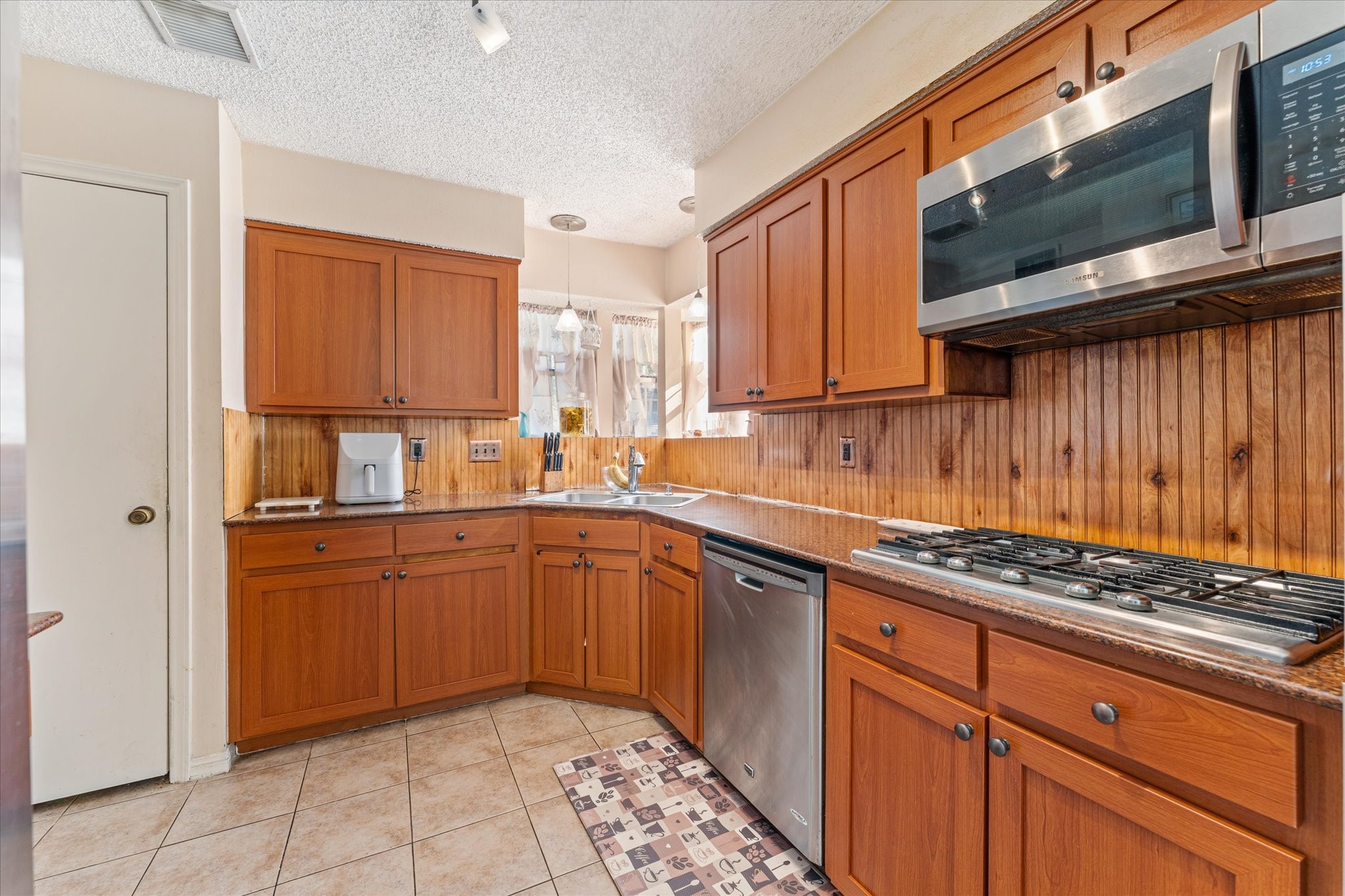 19527 Enchanted Spring Drive Spring, TX 77388 - Photo 6 of 33 a kitchen with stainless steel appliances granite countertop a sink stove and cabinets