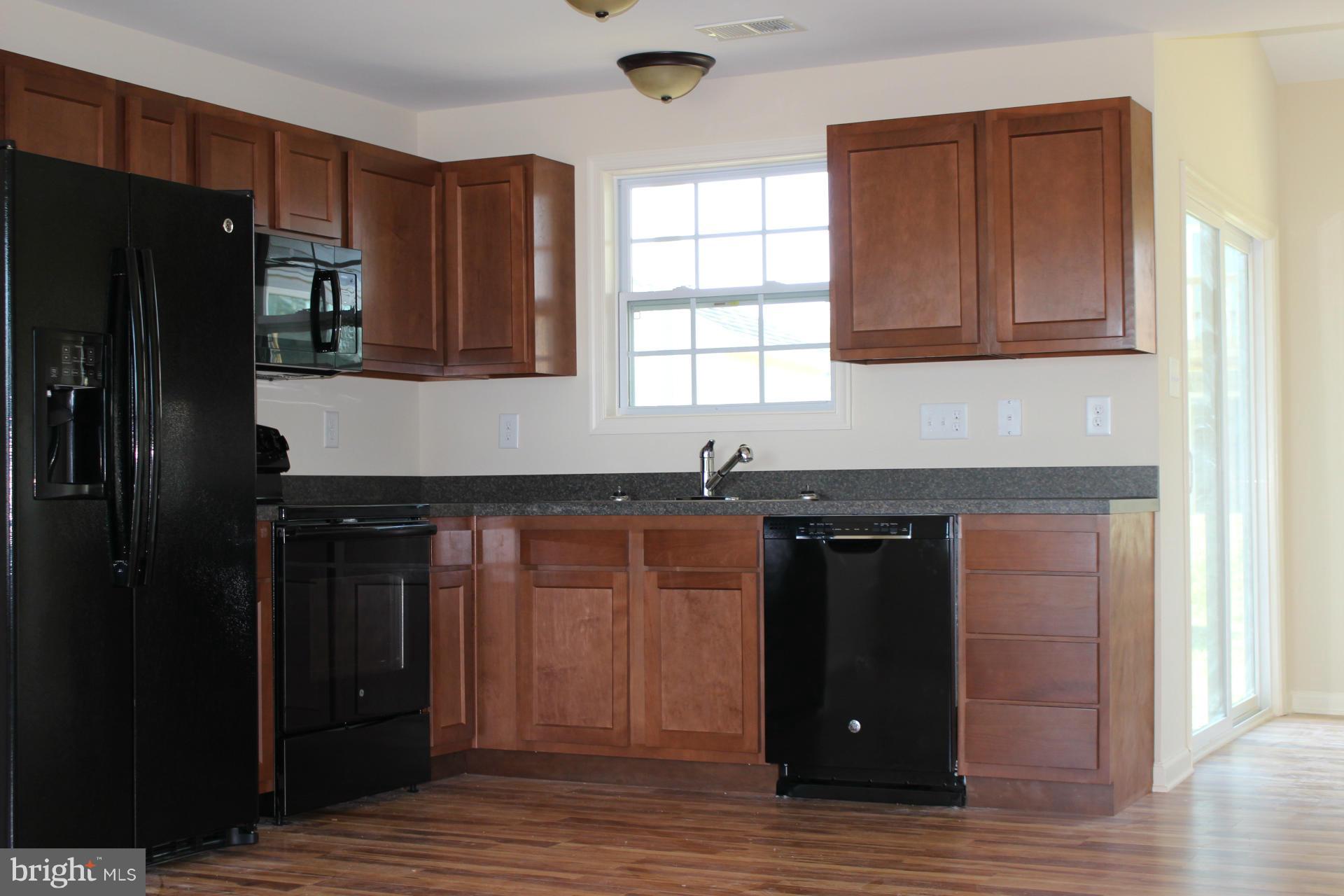 34 Knowledge Court Inwood, WV 25428 - Photo 3 of 12 a kitchen with stainless steel appliances granite countertop a refrigerator and a sink