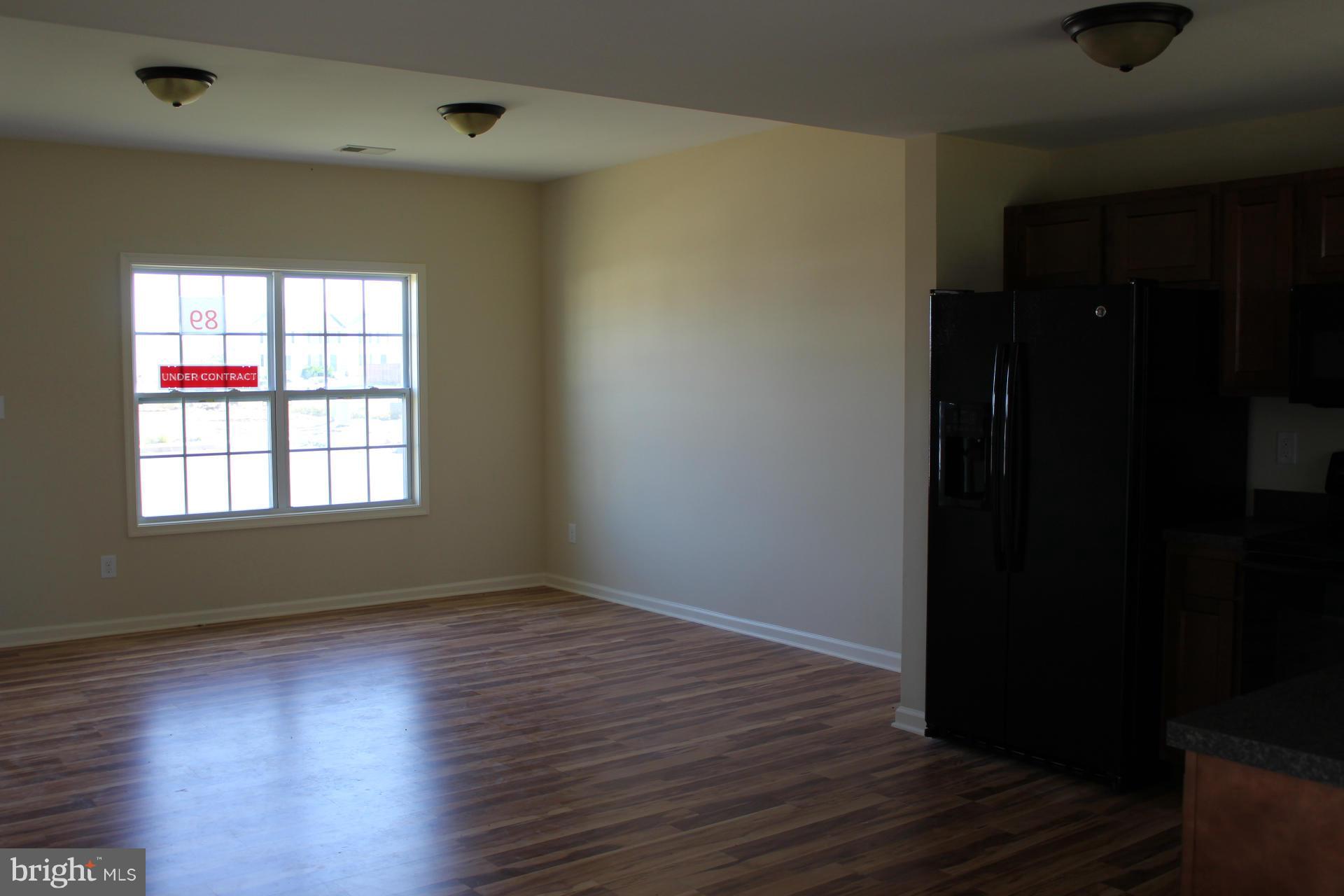 34 Knowledge Court Inwood, WV 25428 - Photo 8 of 12 wooden floor in an empty room with a window