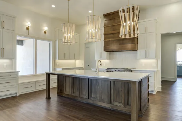 a kitchen with a sink cabinets and window