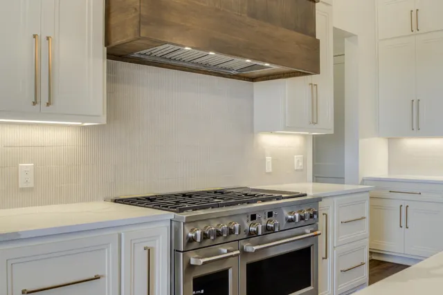 a bathroom with a double vanity sink a mirror and a bathtub