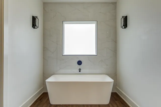 a kitchen with granite countertop stainless steel appliances a stove and wooden floor