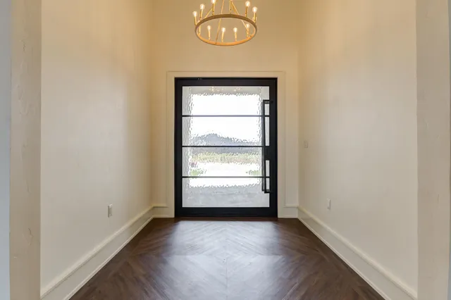 an empty room with wooden floor and closet