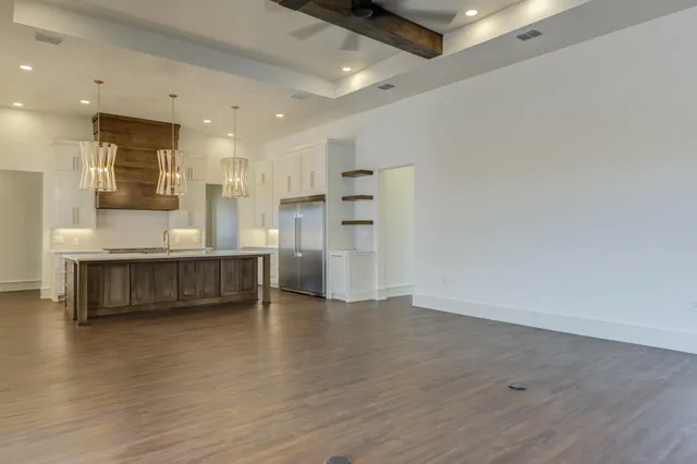 a kitchen with kitchen island a sink stainless steel appliances and cabinets