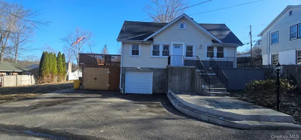 a view of a house with a small yard and sitting area