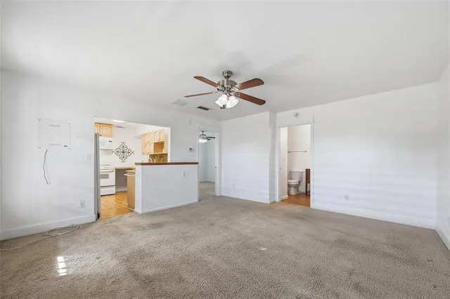 an empty room with closet and windows