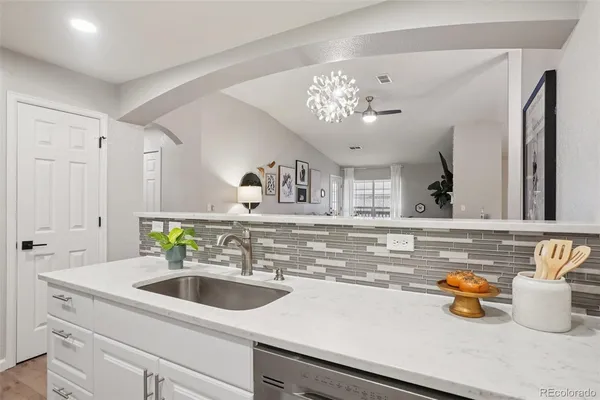 a view with a sink and chandelier