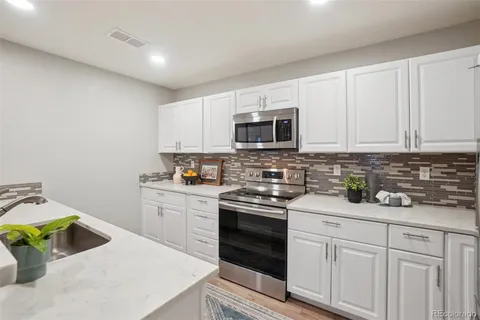 a kitchen with a sink stove and microwave