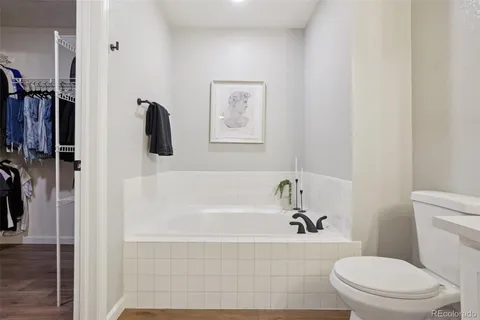 a bathroom with a toilet and a tub