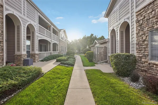 a view of a brick house with a yard
