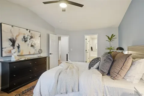 a bedroom with a bed and a painting on the wall