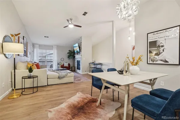 a living room with furniture a chandelier and a table