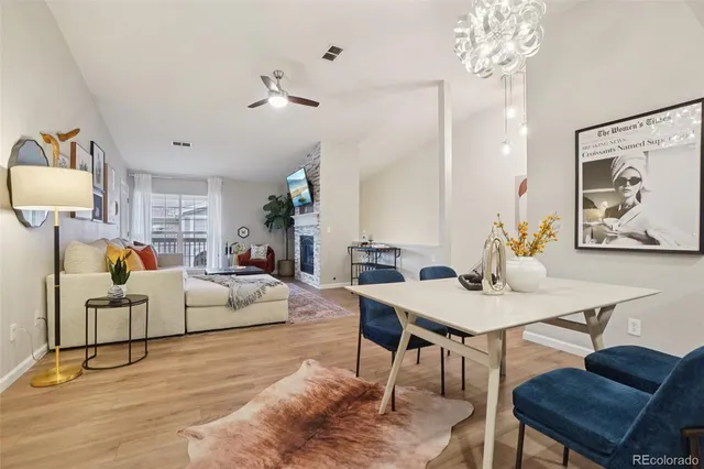 a living room with furniture a chandelier and a table