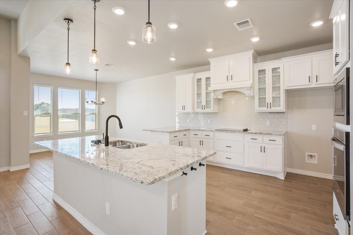 1701 Meadow Crest Salado, TX 76571 - Photo 9 of 30 a large kitchen with kitchen island a sink a center island stainless steel appliances and a cabinets