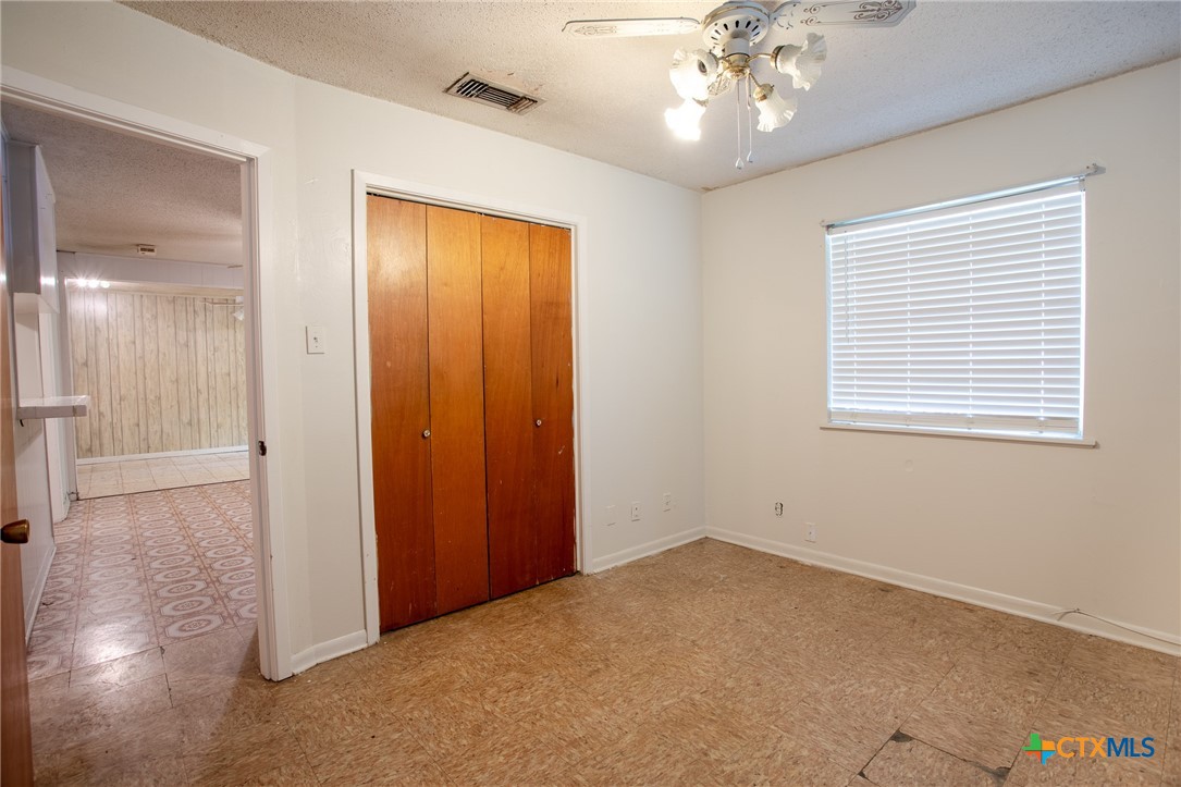 2903 Gayle Street Victoria, TX 77901 - Photo 12 of 21 a view of an empty room with wooden floor and a window