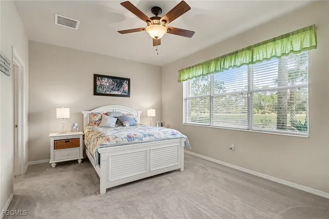 a spacious bedroom with a bed and a window