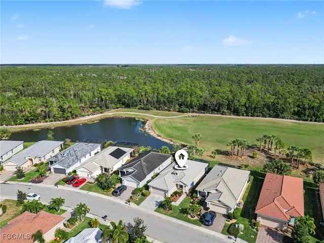 an aerial view of a house with a garden and lake view