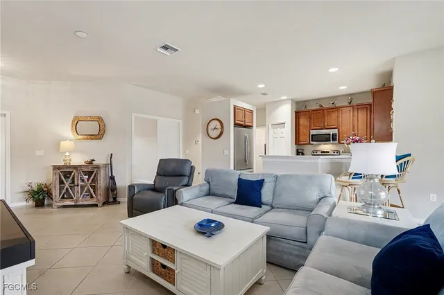 a living room with furniture and kitchen view
