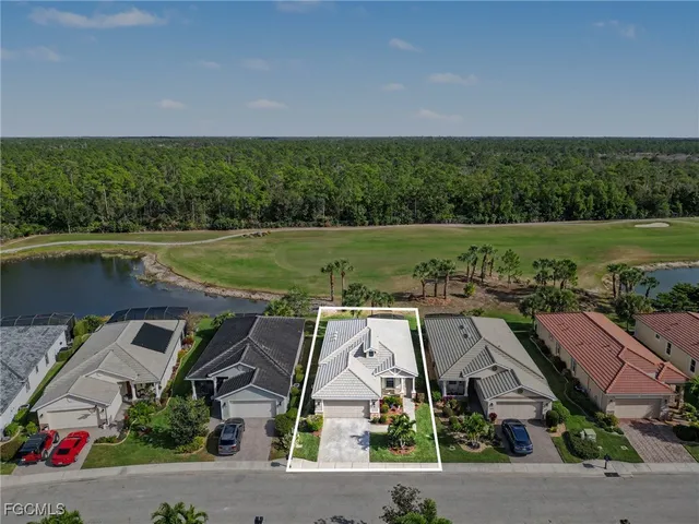 an aerial view of a house with a garden and lake view